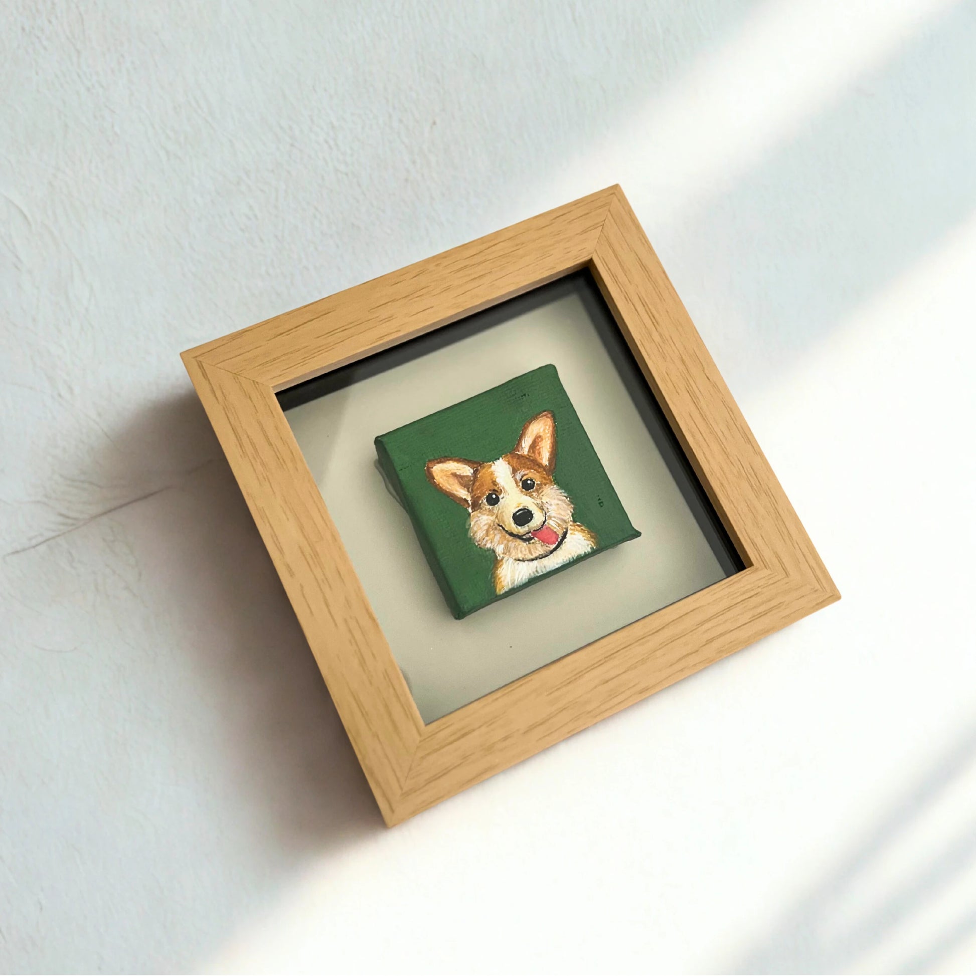 Framed artwork of a dog on a green background